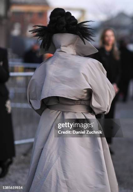 Parris Goebel is seen wearing a tan belted trench coat and black Alexander McQueen boots outside the Alexander McQueen AW22 show on March 15, 2022 in...