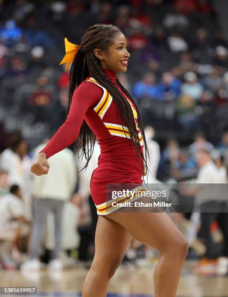 Trojans cheerleader performs during the team's game against the Washington Huskies during the Pac-12 Conference basketball tournament quarterfinals...