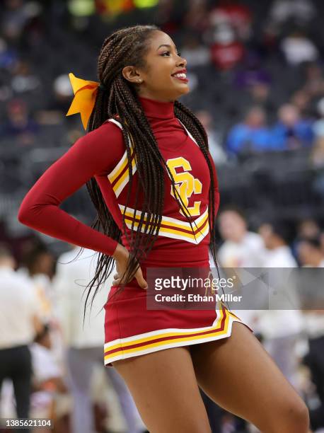 Trojans cheerleader performs during the team's game against the Washington Huskies during the Pac-12 Conference basketball tournament quarterfinals...
