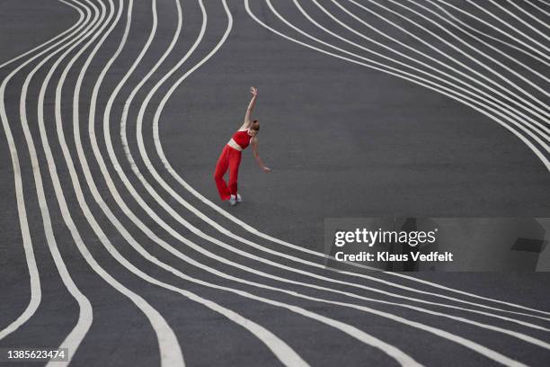 female dancer practicing ballet on road - beweglichkeit stock-fotos und bilder