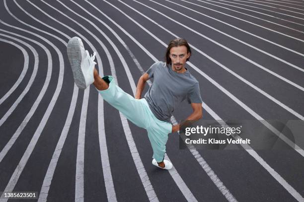 male dancer practicing on striped road - treten stock-fotos und bilder