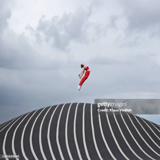 woman jumping while practicing ballet - in der luft schwebend stock-fotos und bilder