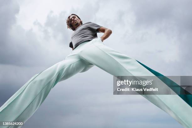 male dancer practicing ballet - grey trousers stock-fotos und bilder