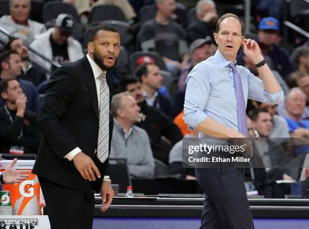 Assistant coach Will Conroy and head coach Mike Hopkins of the Washington Huskies look on as the team takes on the USC Trojans during the Pac-12...