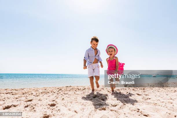 cheerful kids having fun in summer day on the beach. - egyptian family stock pictures, royalty-free photos & images