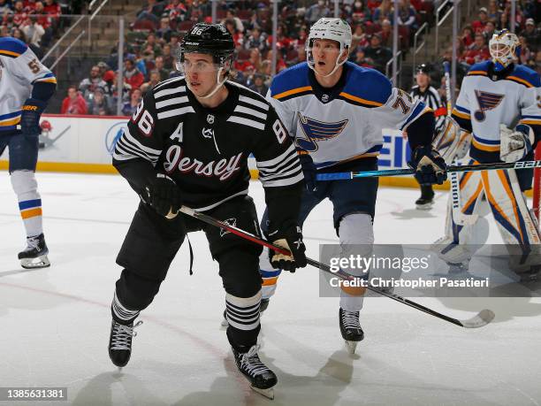 Jack Hughes of the New Jersey Devils skates against Niko Mikkola of the St. Louis Blues during the first period at the Prudential Center on March 6,...