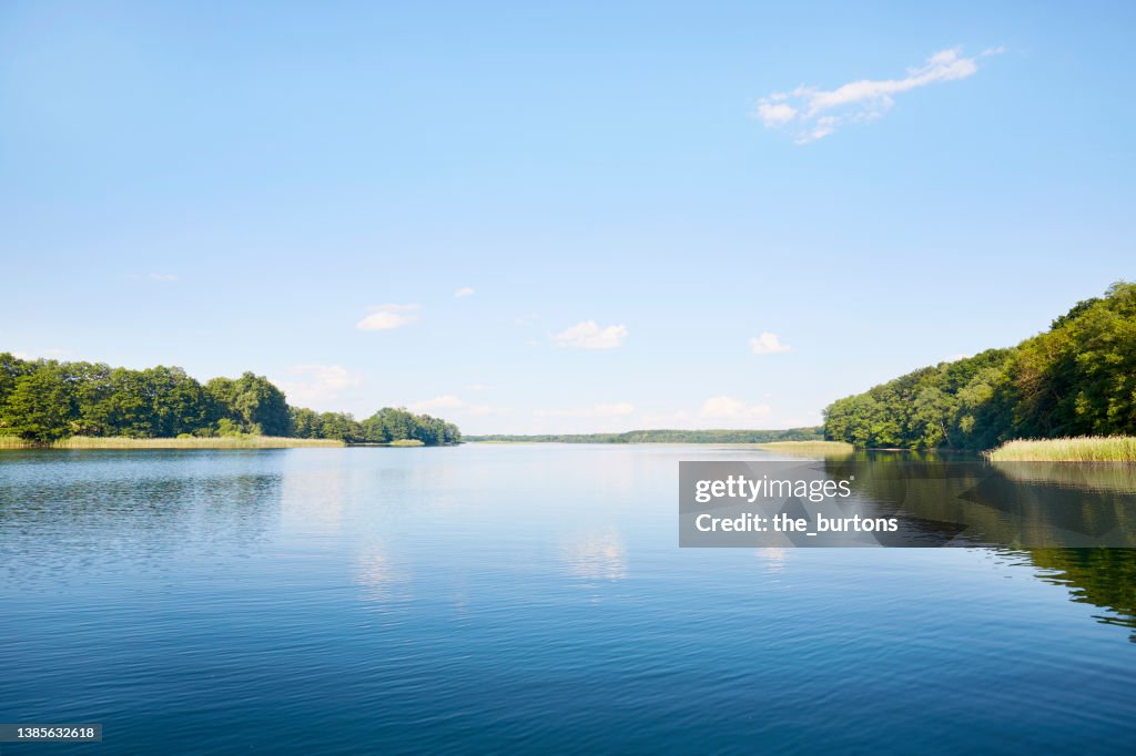 Idyllic lake and clear sky, the blue sky is reflected in the smooth water
