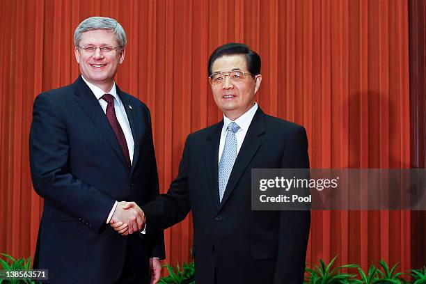 Canadian Prime Minister Stephen Harper is greeted by Chinese President Hu Jintao before their meeting at the Great Hall of the People on February 9,...