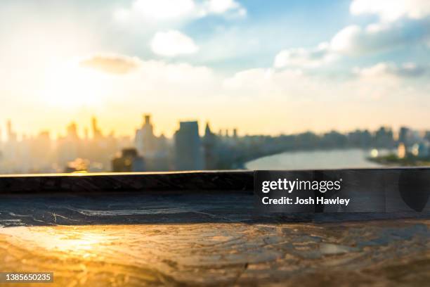 wood table with cityscape background - sunset city stock pictures, royalty-free photos & images