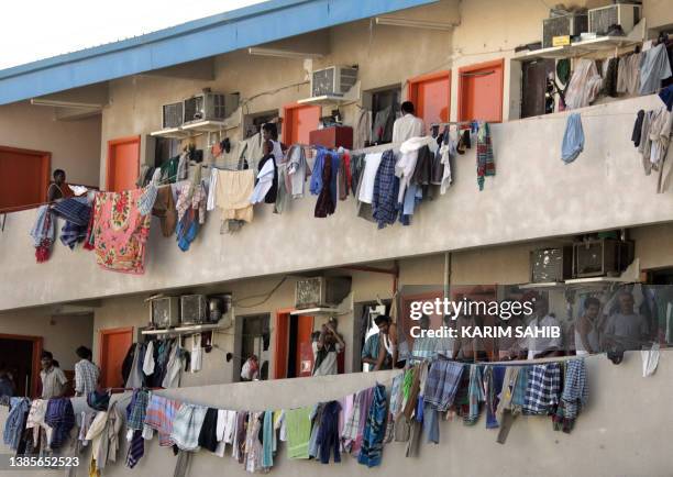 Striking Asian workers stay at home crowding on their balconies among the drying laundry in Sonapur camp, on the outskirts of Dubai, 31 October 2007,...