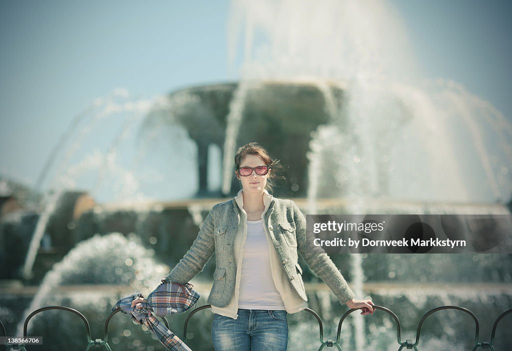 Young woman with plaid scarf in her hand