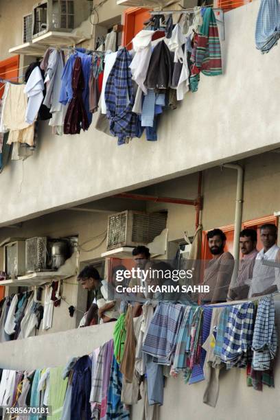 Striking Asian workers stay at home crowding on their balconies among the drying laundry in Sonapur camp, on the outskirts of Dubai, 31 October 2007,...