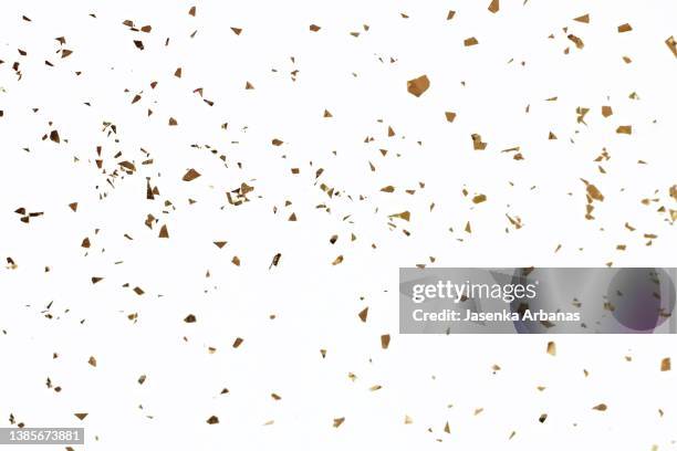golden confetti on the white background - confetti gold ストックフォトと画像