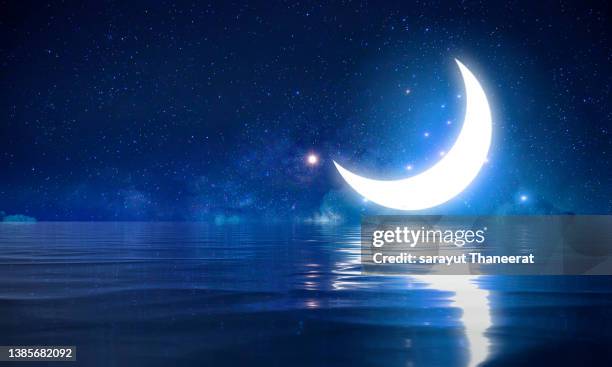 ramadan kareem the moon in the sea at night among the stars - ramadan moon stockfoto's en -beelden