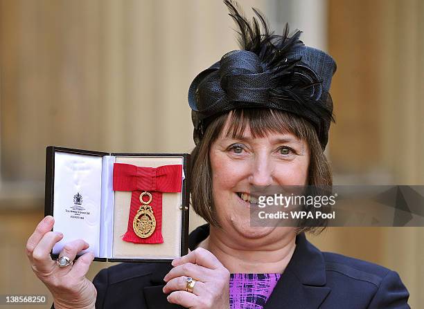 Dr Frances Saunders holds her most Honourable Order of the Bath award, after it was presented to her by the Prince of Wales, during an Investiture...