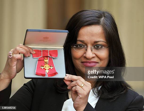 Professor Mona Siddiqui holds her Officer of the British Empire medal, after it was presented to her by the Prince of Wales, during an Investiture...