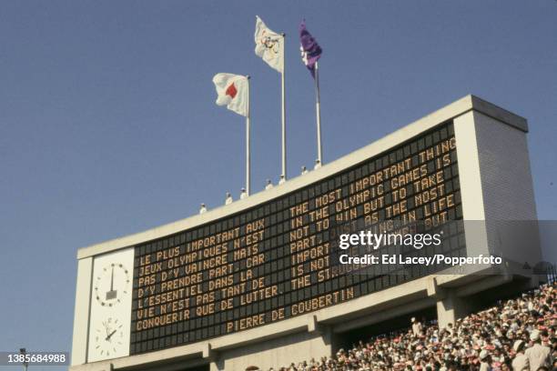 The electronic scoreboard displays the Olympic creed during the opening ceremony for the 1964 Summer Olympics inside the National Stadium in Tokyo,...