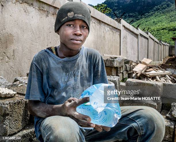 Enfant avec un sachet plastique contenant de l'eau le 27 octobre 2021 à Conakry en Guinée.