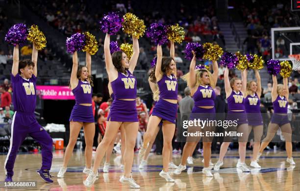 Washington Huskies cheerleaders perform during the team's game against the Utah Utes during the first round of the Pac-12 Conference basketball...