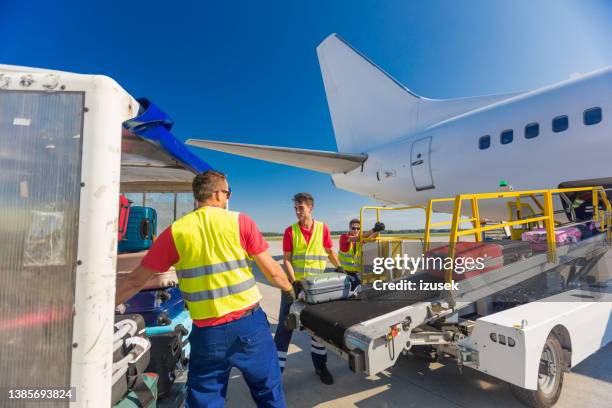 airport service crew loading luggage - lasta bildbanksfoton och bilder