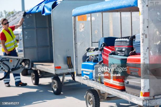 suitcases in a trolley at tth arisport - ground crew stock pictures, royalty-free photos & images
