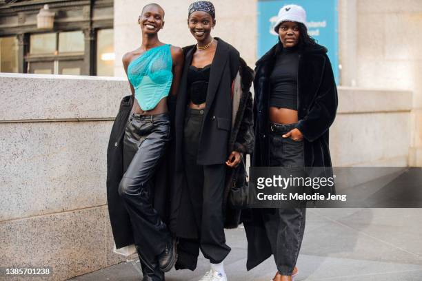 Models Adot Gok, Aliet Sarah, and Angeer Amol after the Victor Glemaud show at Moynihan Train Hall during New York Fashion Week Fall/Winter 2022 on...
