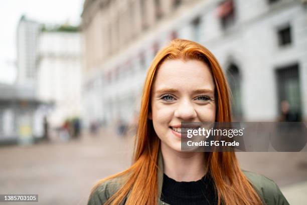 portrait of a young woman in the street - young woman red hair urban stock pictures, royalty-free photos & images