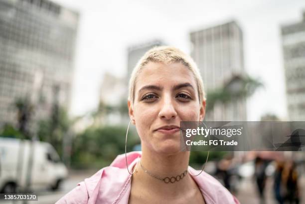 portrait of a young woman in the street - shaved head stock pictures, royalty-free photos & images