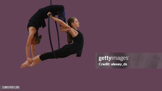 two aerial acrobats on aerial hoop, series of photos - lyra stock pictures, royalty-free photos & images