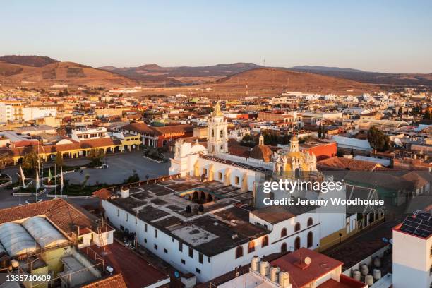 aerial view of the zócalo and the church of santiago apostol at sunrise - chignahuapan stock pictures, royalty-free photos & images