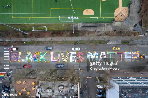 In an aerial view, a Black Lives Matter mural stretches across a city block in front of Cal Anderson Park on March 13, 2022 in Seattle, Washington....