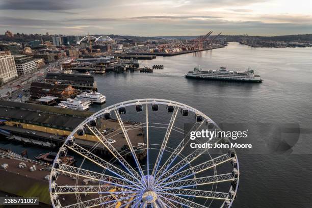 In an aerial view, a ferry boat departs as Seattle's 175-foot Great Wheel and the Port of Seattle are seen on the waterfront on March 11, 2022 in...