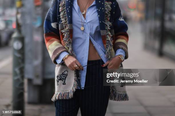 Nina Suess is seen wearing Christian Dior Vibe Hobo black and white bag, Victoria Beckham baby blue stripe blouse, Alanui knit colorful cardigan,...