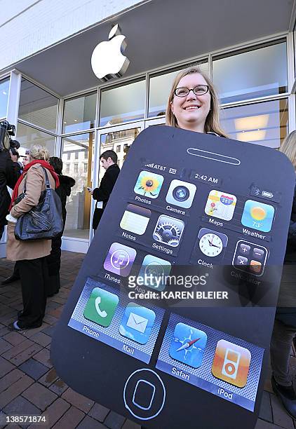 Amanda Kloer, Director of Organizing at Campaign on Change.org, seen wearing an iPhone placard, during a protest in front of the Apple store in...