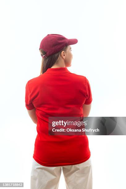 back view of woman in red t-shirt polo - red t shirt stock pictures, royalty-free photos & images