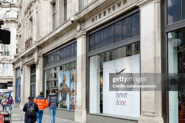 exterior of niketown sports store with people on city street in london, uk - daily life at oxford street london stock pictures, royalty-free photos & images