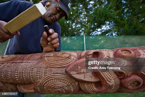 Moari man finely carves details into a wooden trunk to create unique Moari art on Feburary 10, 2010 in Rotorua, New Zealand.