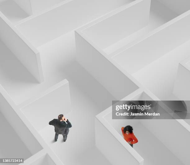 man and woman lost in the maze - gender gap stock pictures, royalty-free photos & images