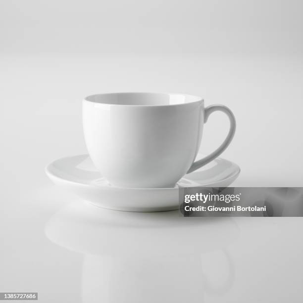 white teacup on white background - tea cup photos et images de collection