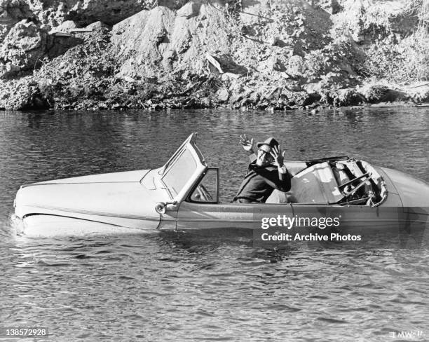 Phil Silvers in car sinking in lake in a scene from the film 'It's A Mad Mad Mad Mad World', 1963.