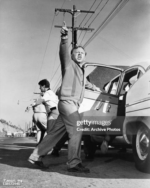 Mickey Rooney pointing entering car in a scene from the film 'It's A Mad Mad Mad Mad World', 1963.