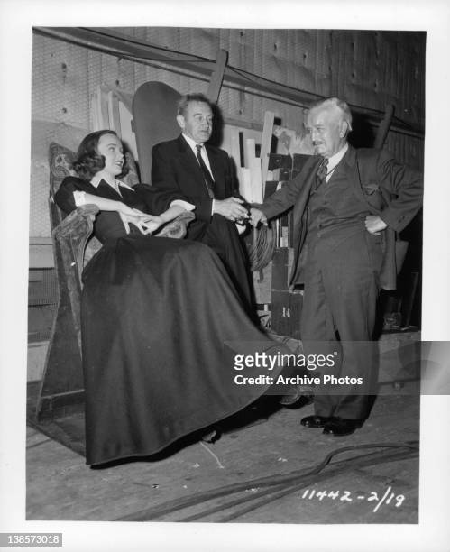 Wanda Hendrix enjoys a between scenes visit with Barry Fitzgerald during the filming 'Miss Tatlock's Millions', 1948.