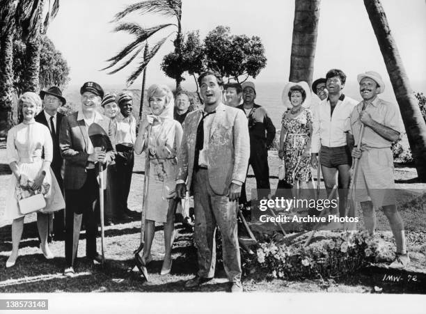 Ethel Merman covered in dirt wearing hat with others in a scene from the film 'It's A Mad Mad Mad Mad World', 1963.