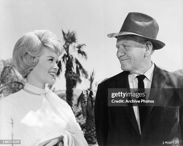 Dorothy Provine smiling with Spencer Tracy in a scene from the film 'It's A Mad Mad Mad Mad World', 1963.