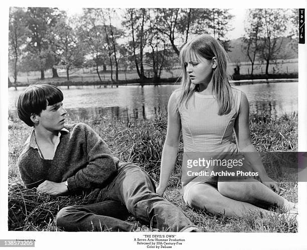 Martin Stephens and Ingrid Brett play school sweethearts with a dark secret in a scene from the film 'The Devil's Own', 1966.