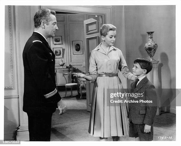 Deborah Kerr introduces Martin Stephens to his long absent father, Rossano Brazzi in a scene from the film 'Count Your Blessings', 1958.