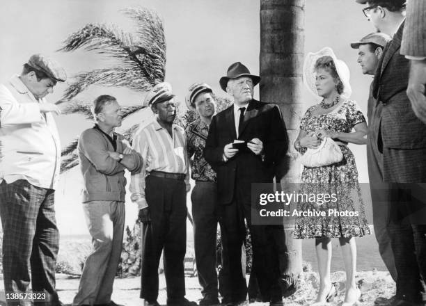 Buddy Hackett and Mickey Rooney standing with others in a scene from the film 'It's A Mad Mad Mad Mad World', 1963.