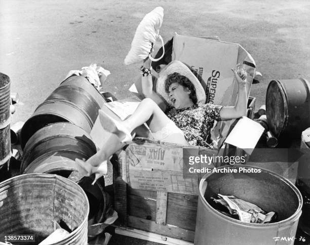 Ethel Merman falls in crate of trash in a scene from the film 'It's A Mad Mad Mad Mad World', 1963.