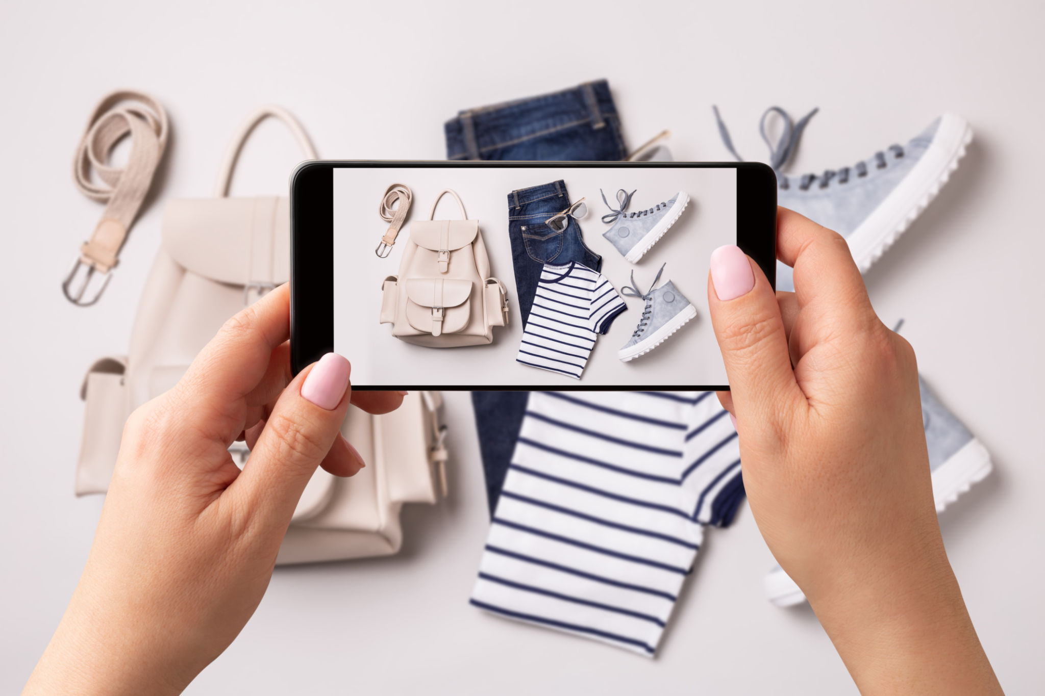 Woman taking photo of spring fashion outfit and accessories with smartphone. Influencer and social media. Woman taking photo of spring fashion outfit and accessories with smartphone. Influencer and social media.