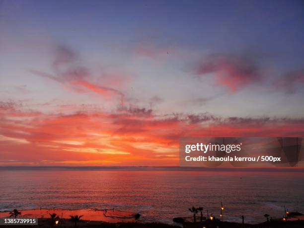 the show stopper,scenic view of sea against dramatic sky during sunset - khaoula stock pictures, royalty-free photos & images